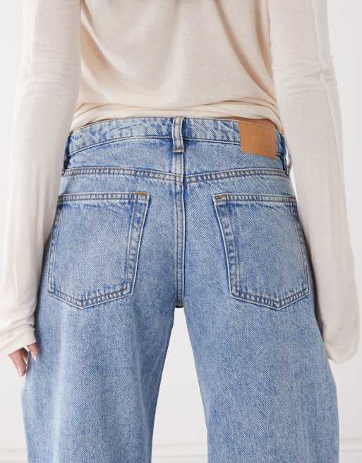 Monki Imoo low waist wide leg jeans with cut out bow details in light blue wash, 4 of 5