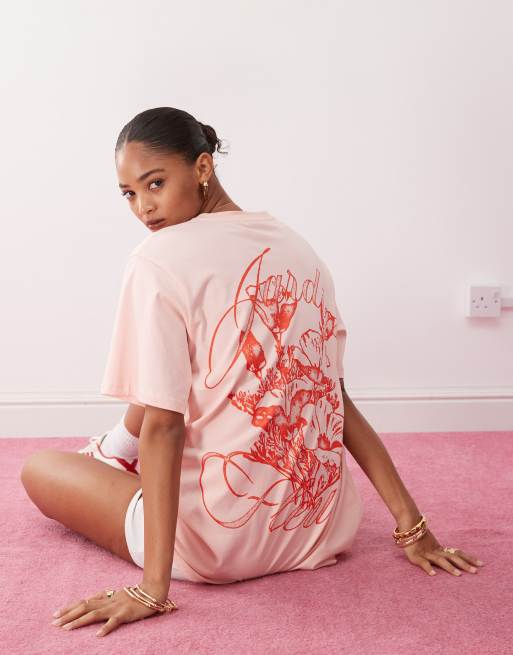 Monki – Jasnoróżowy T-shirt oversize z grafiką z pomarańczowym kwiatem
