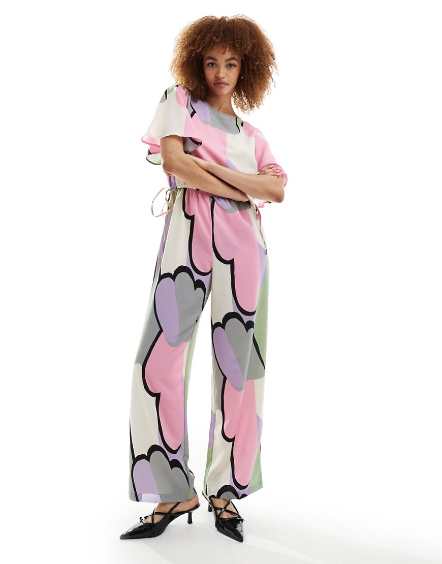Monki jumpsuit with tie waist detail in multi cloud print