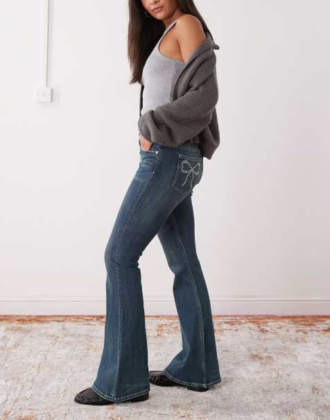 Monki Katsumi low waist flare jeans with bow embellishment