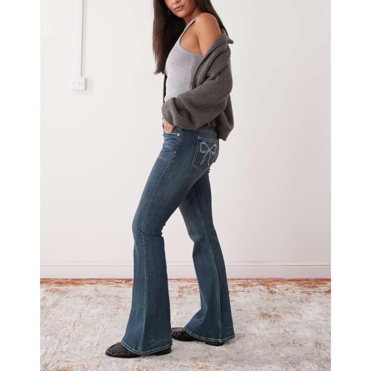 Monki Katsumi low waist flare jeans with bow embellishment | ASOS