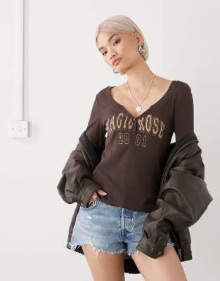 Monki Long Sleeve Henley Button Top With Flared Sleeves And Yellow Varsity Print In Brown