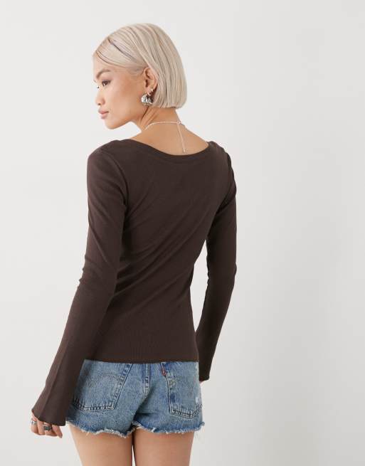 Monki long sleeve henley button top with flared sleeves and yellow varsity print in washed chocolate brown