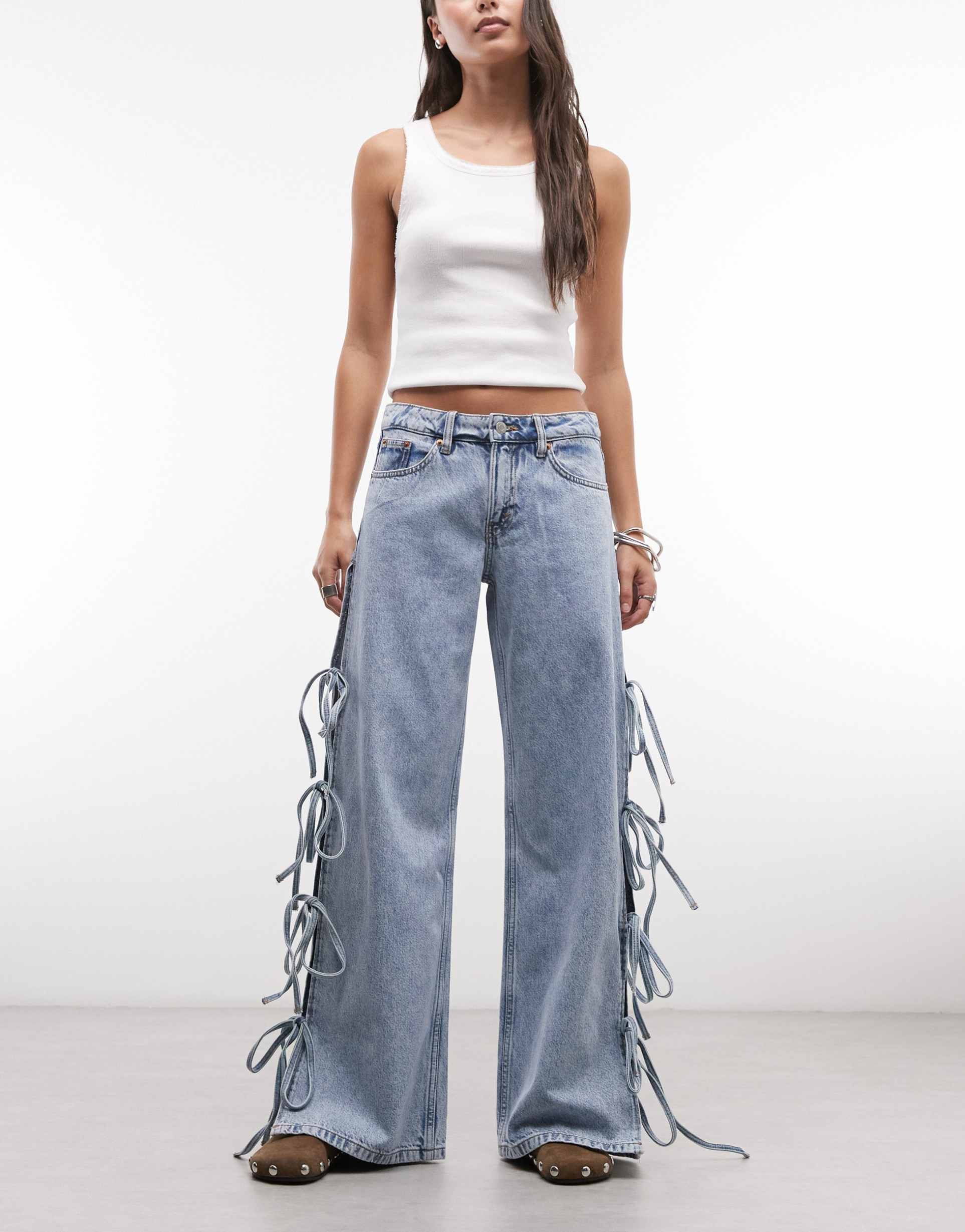 monki low waist wide leg jeans with side tie bow detailing in blue wash