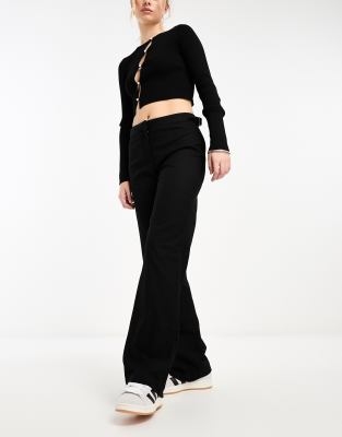 low waisted pants with side buckle detail in black