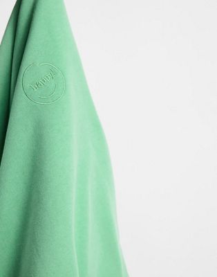 Sweats à capuche Monki - Nana - Sweat en coton biologique à logo Happy - Vert