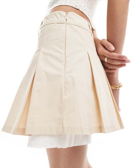 Monki pleated mini skirt with white layered raw hem detail in beige