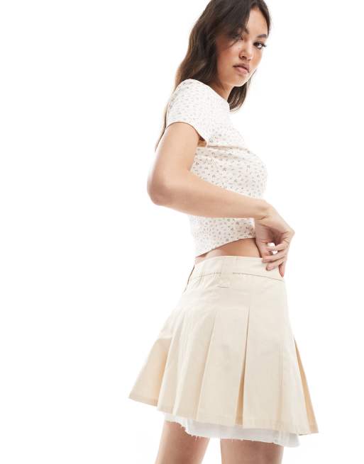 Monki pleated mini skirt with white layered raw hem detail in beige