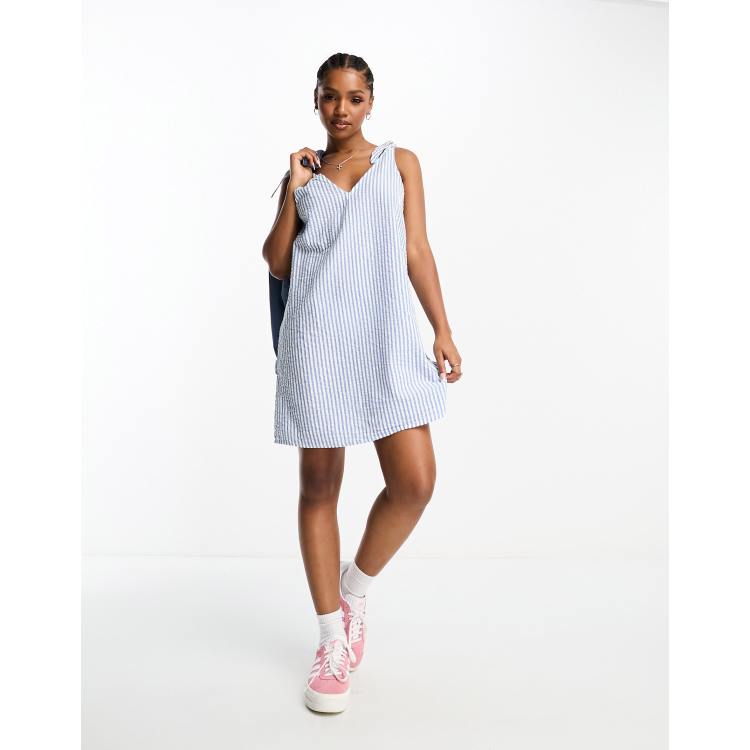 Monki seersucker bow tie strap mini dress with side pockets in blue and  white stripe