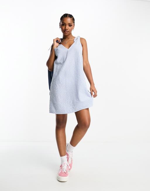 Monki seersucker bow tie strap mini dress with side pockets in blue and white stripe