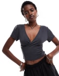 [Monki] Monki super soft cropped short sleeve top with wrap front detail in black-White 2XS Black