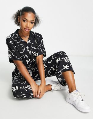 Monki tie waist jumpsuit in black and white face and moon print
