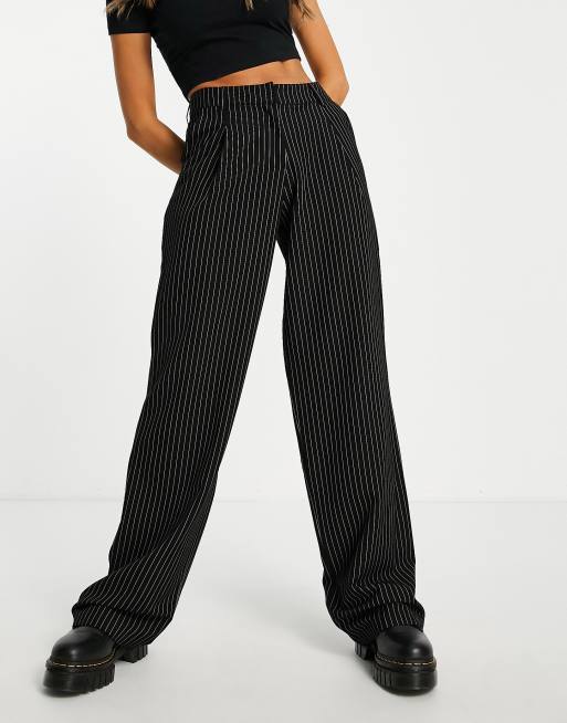 Motel pinstripe slouchy low rise trousers in black