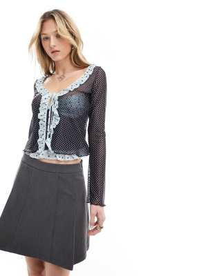 polka dot ruffle edge tie-front blouse in blue and black