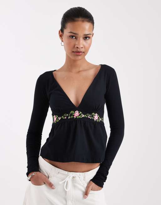 Motel - Yahop - Top nero a maniche lunghe con scollo profondo e dettagli floreali