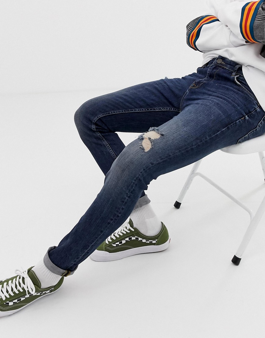 Mørkeblå forvaskede skinny jeans med flænger fra ASOS DESIGN