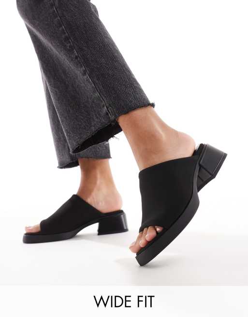 Mules negros de tacón bajo con suela gruesa de London Rebel Wide Fit