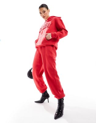 Murci exclusive saint motif joggers co-ord in red