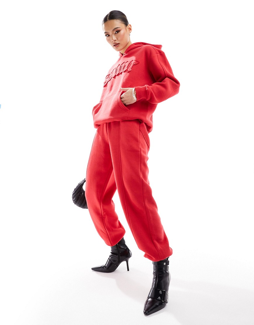 Murci exclusive saint motif joggers co-ord in red