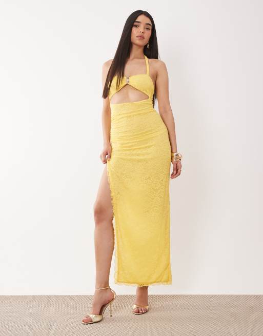 Murci - Vestito lungo in pizzo giallo allacciato al collo con dettagli in metallo e cut-out