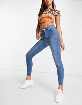 NA-KD cotton skinny high waist jeans with raw hem in mid blue - MBLUE