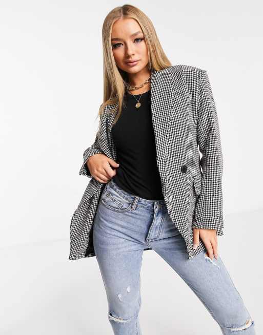 a houndstooth blazer and black denim jeans