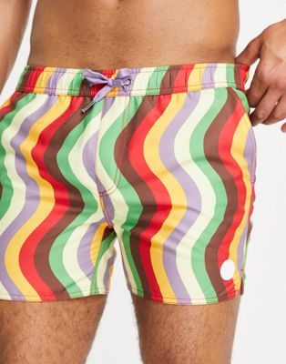 Native Youth swim shorts in red and green wavey print