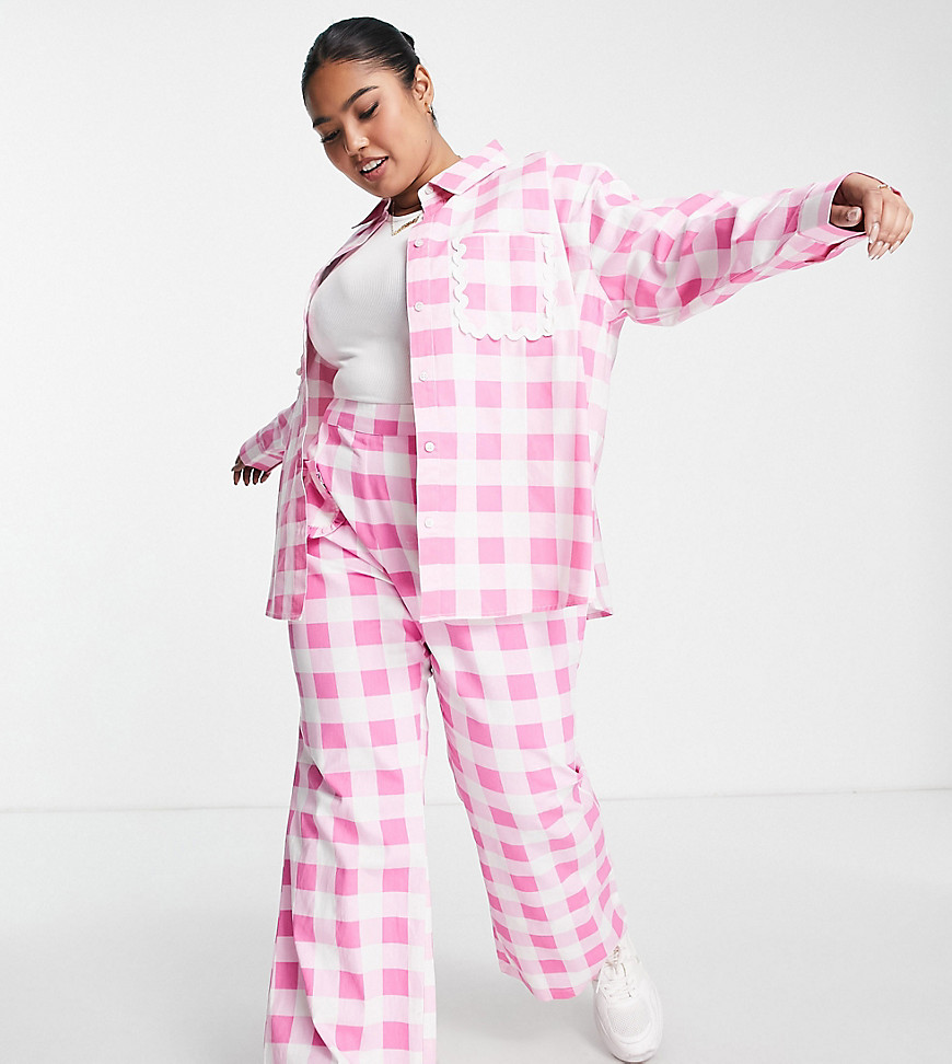 Plus-size shirt by Neon Rose Exclusive to ASOS Trousers sold separately Gingham design Spread collar Button placket Drop shoulders Chest pockets with frill trim Oversized fit