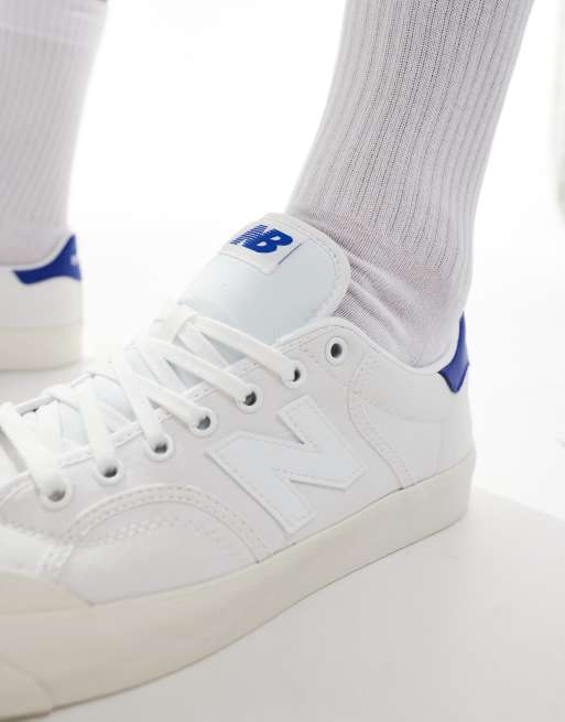 New Balance 100 trainers in white and blue