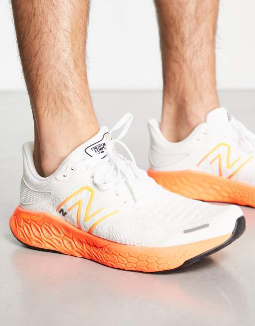 New Balance 1080 Baskets de course Blanc et orange