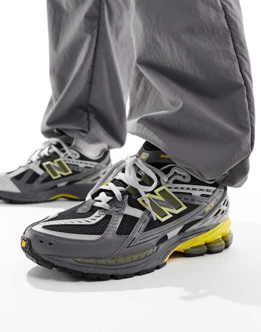 New Balance 1906 Baskets Gris fonc et jaune