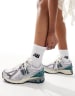 New Balance 1906 sneakers in white with blue and pink details