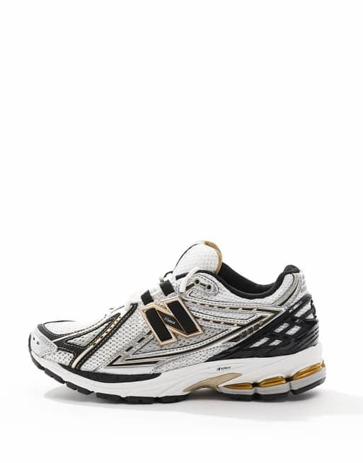 New Balance 1906 sneakers in gold and black