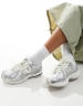 New Balance 1906 sneakers in white with blue and pink details