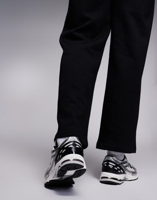 New Balance 1906 sneakers in white with black and silver