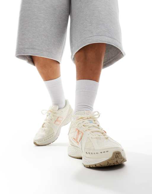 New Balance 1906 sneakers in white with blue and pink details