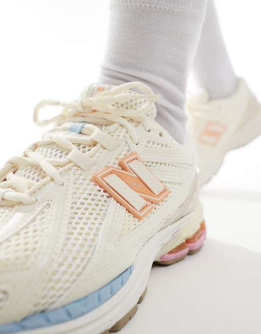 New Balance 1906 sneakers in white with blue and pink details