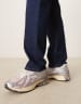 New Balance 1906 sneakers in white with blue and pink details