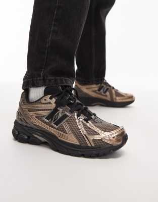 New Balance 1906R unisex trainers in gold and black