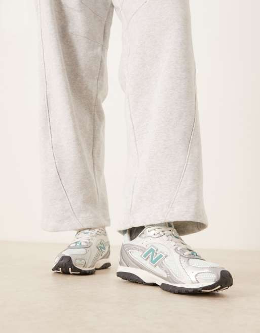 New Balance 204L trainers in silver metallic and blue, 5 of 5