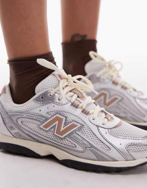 New Balance 204L unisex trainers in white and brown