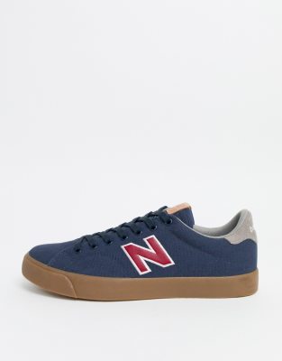 new balance 210 trainers in navy with gum sole