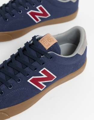 new balance 210 trainers in navy with gum sole
