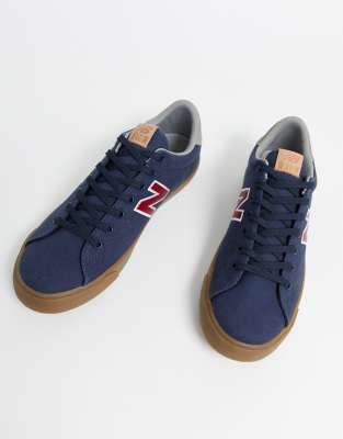 new balance 210 trainers in navy with gum sole