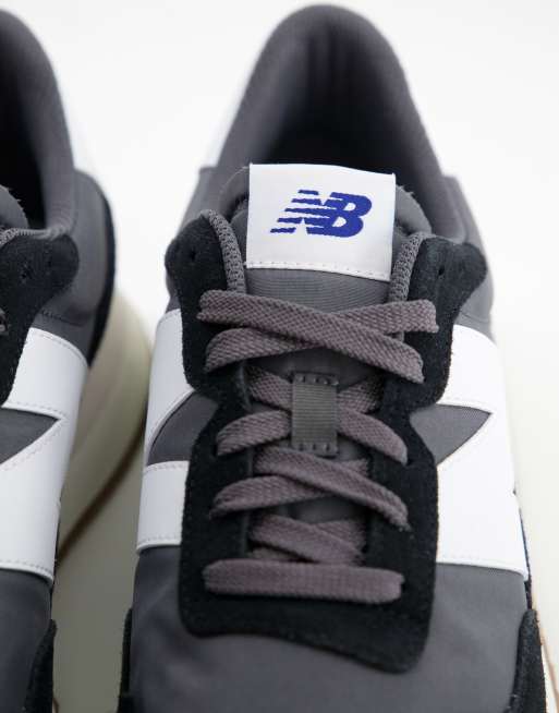 New Balance 237 sneakers in black with gum sole