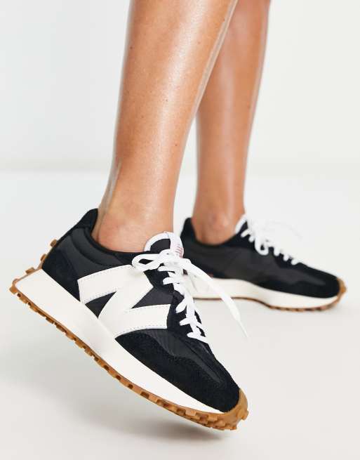 New Balance 327 sneakers in black with gum sole