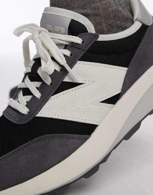 New Balance 370 trainers in dark grey ASOS