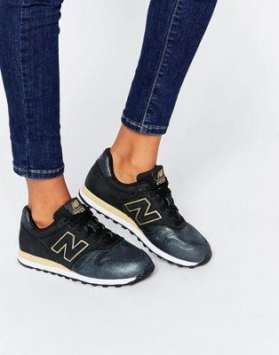 new balance 373 trainers in black and gold