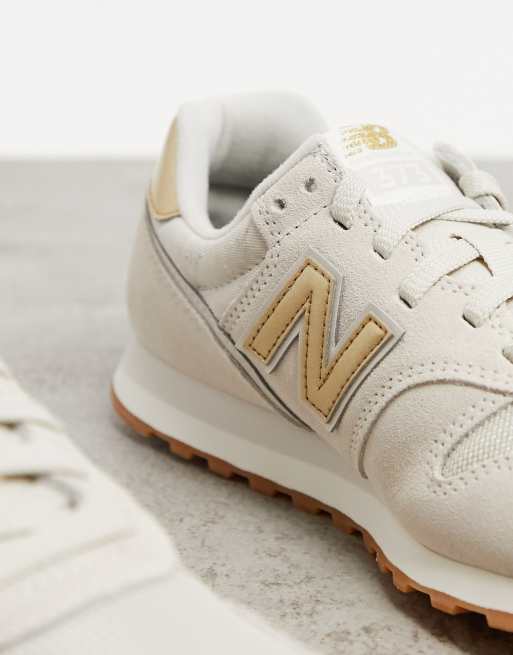 New Balance 373 Sneakers color crema e oro ASOS