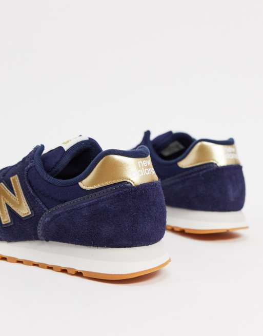 New Balance 373 sneakers in navy and gold